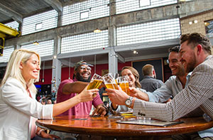 Toasting with beers in a bar